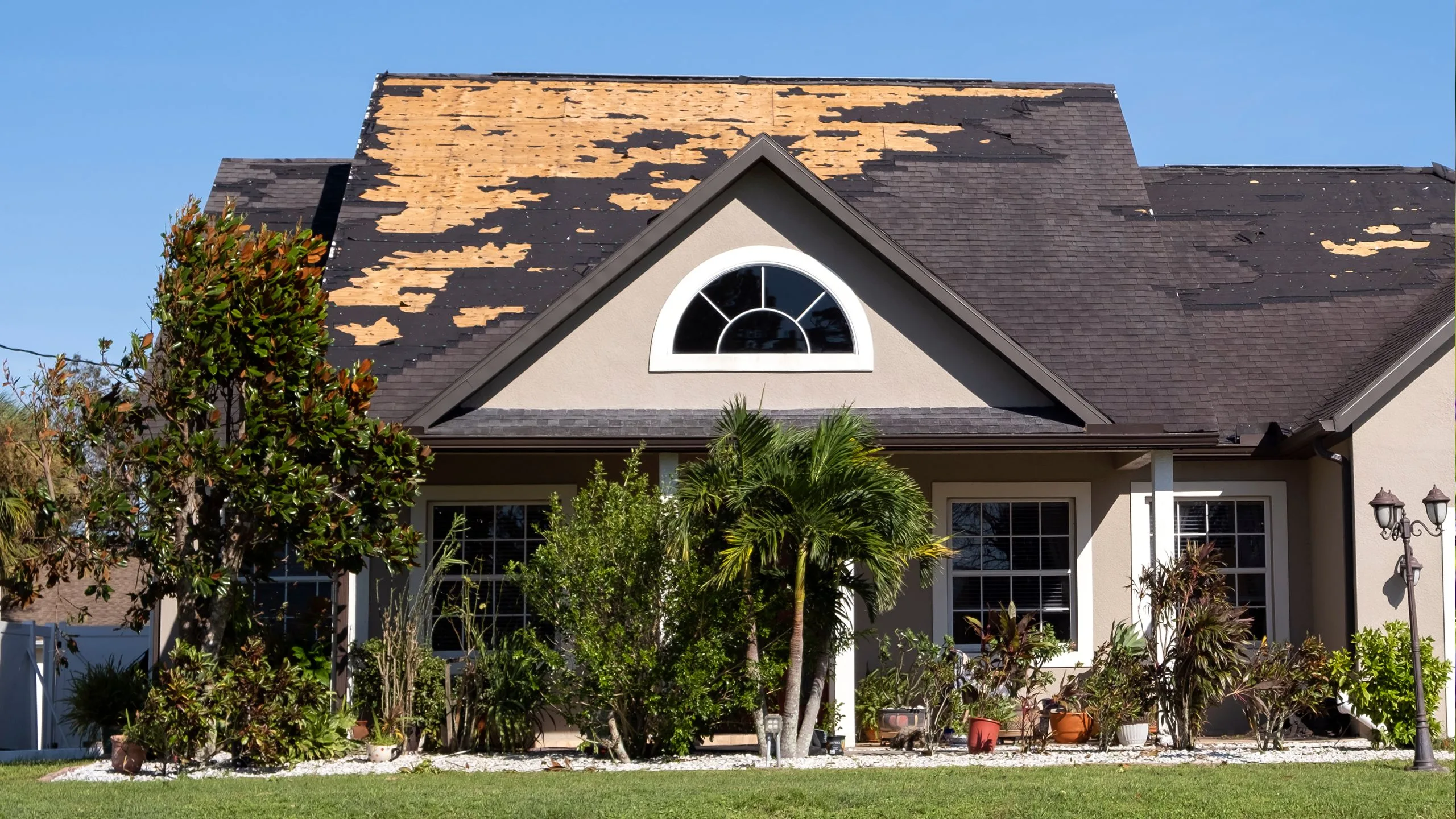 Hamilton home exterior showing signs of winter damage in early spring including worn siding and roofline wear